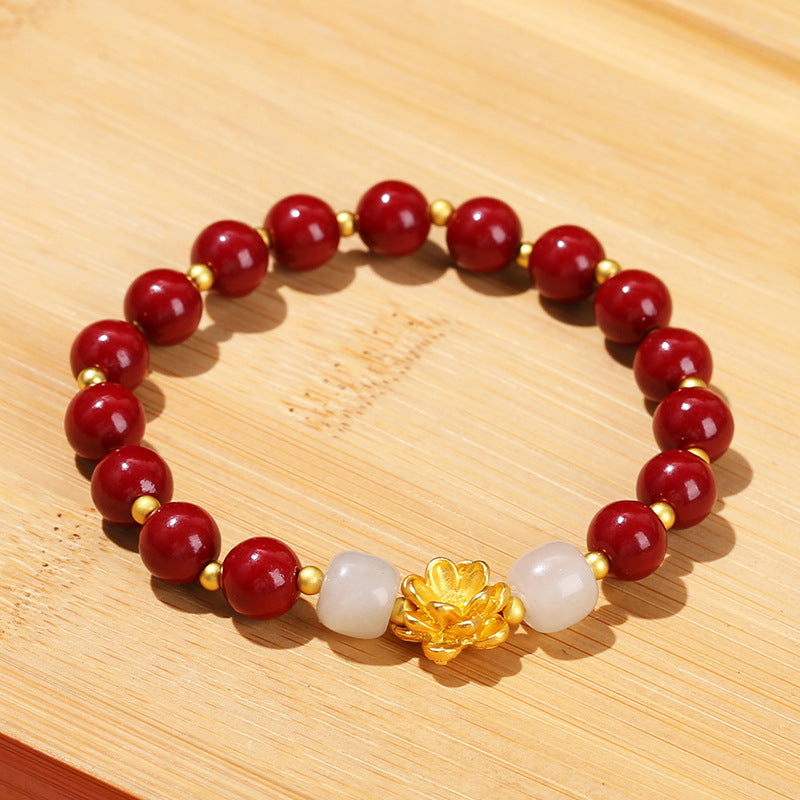 Pulsera de loto de metal arena dorada morada.
