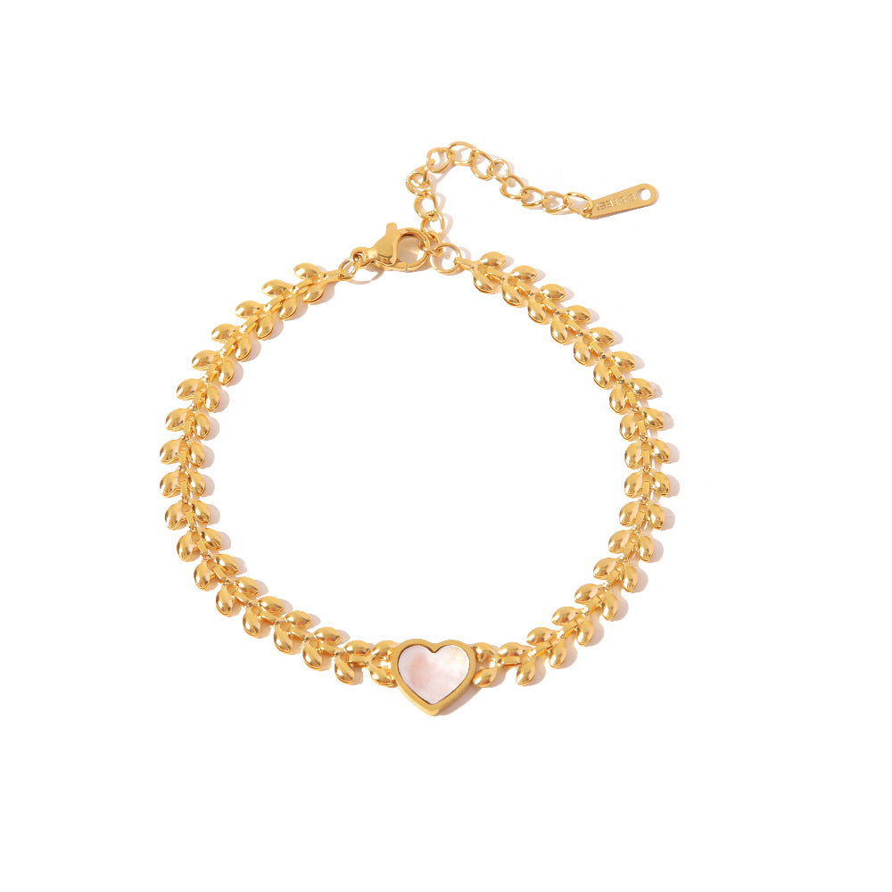 Pulsera de acero de titanio con corazón de amor y conchas marinas