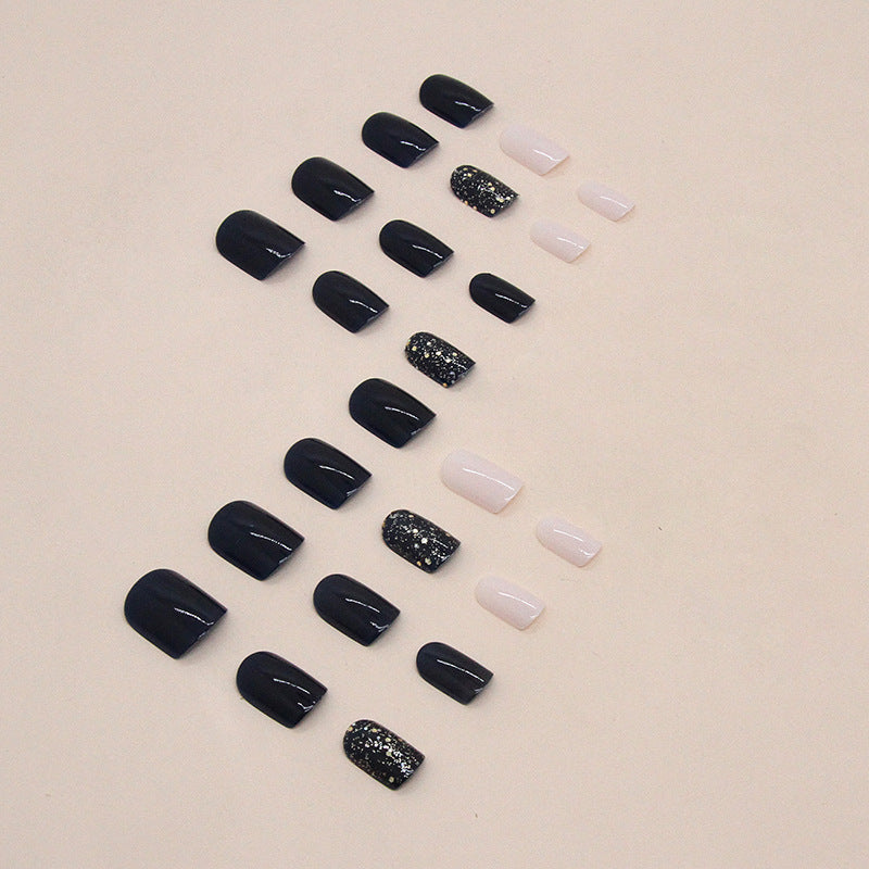 Uñas postizas cortas con purpurina y estrellas en color azul oscuro