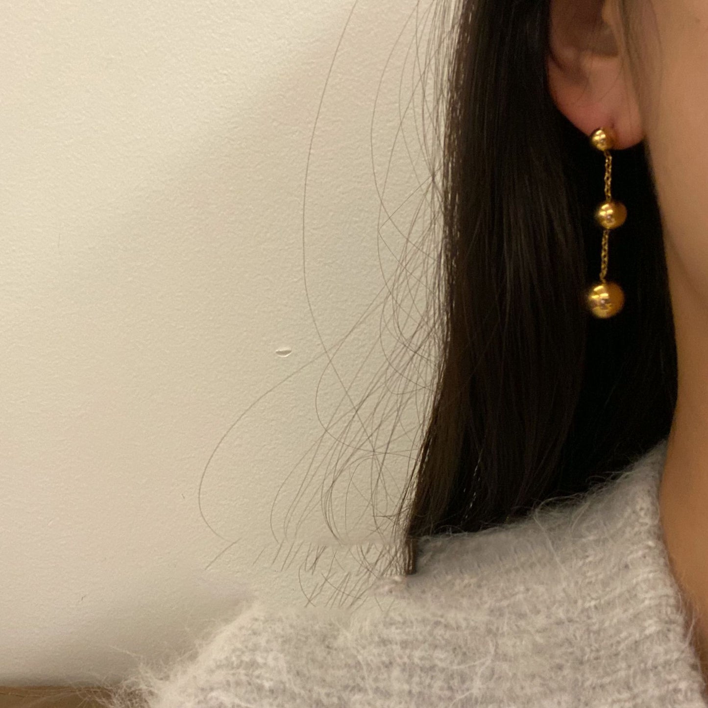 Three gold bead fringed earrings.