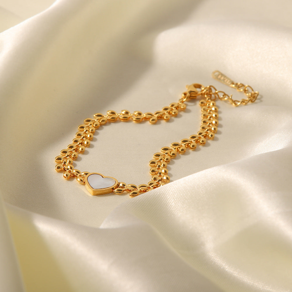 Pulsera de acero de titanio con corazón de amor y conchas marinas 