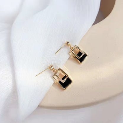 Black and white short pendant earrings.