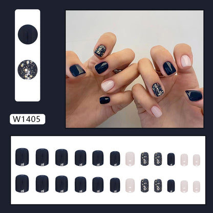 Uñas postizas cortas con purpurina y estrellas en color azul oscuro 