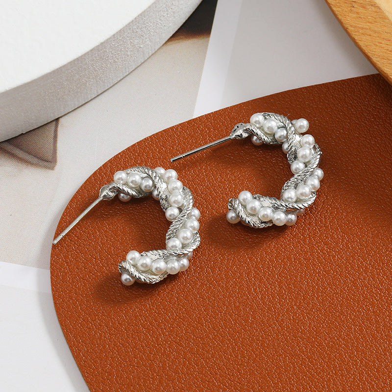 C-shaped earrings, pearl earrings.