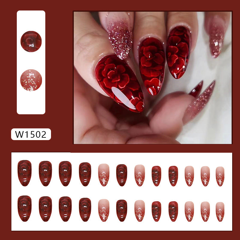 Uñas postizas con purpurina y forma de almendra con flores rojas 