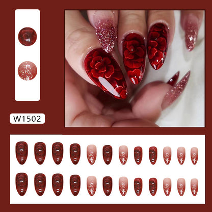 Uñas postizas con purpurina y forma de almendra con flores rojas 