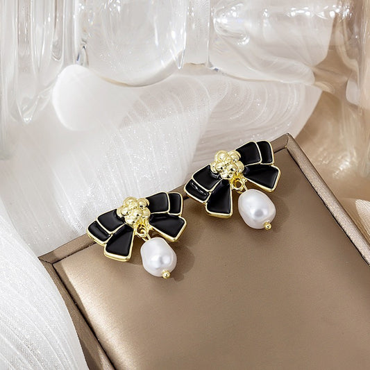 Black and white bow pearl earrings