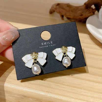 Black and white bow pearl earrings