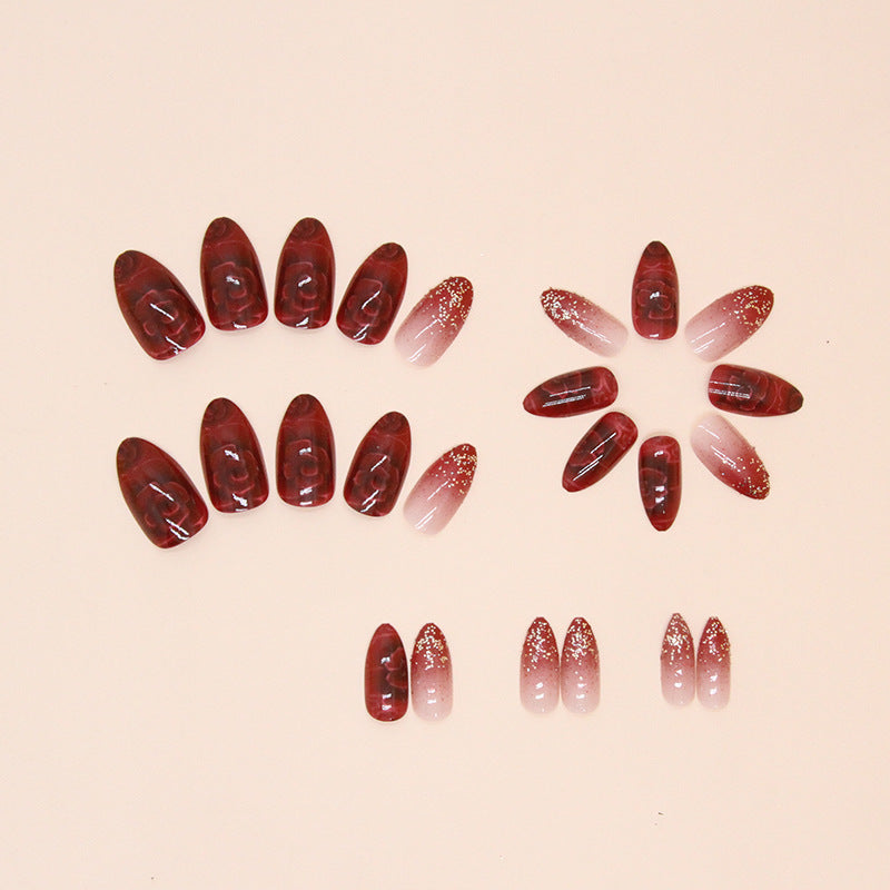 Uñas postizas con purpurina y forma de almendra con flores rojas 
