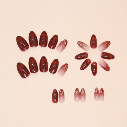 Uñas postizas con purpurina y forma de almendra con flores rojas 