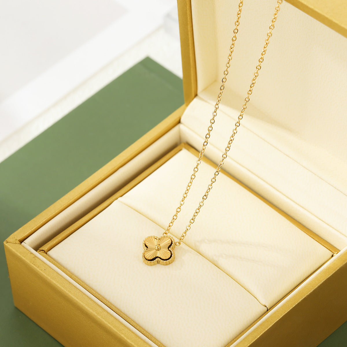 Embossed four-leaf clover titanium steel necklace