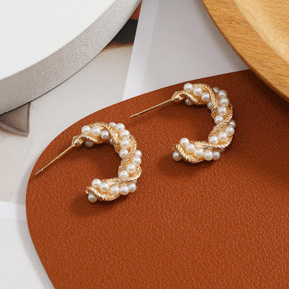 C-shaped earrings, pearl earrings.
