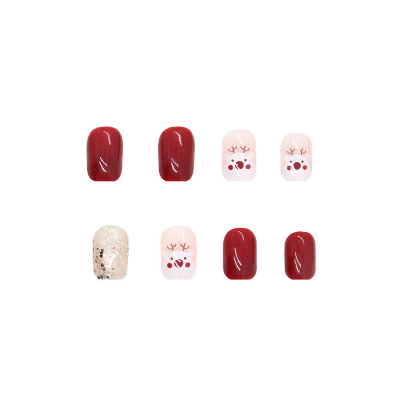 Uñas navideñas con renos en color rojo granada 
