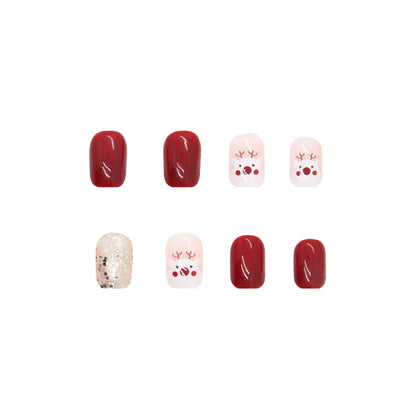 Uñas navideñas con renos en color rojo granada 