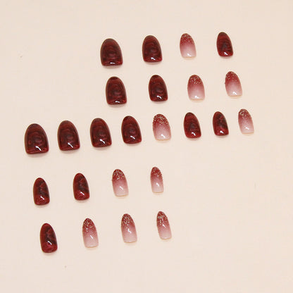 Uñas postizas con purpurina y forma de almendra con flores rojas 
