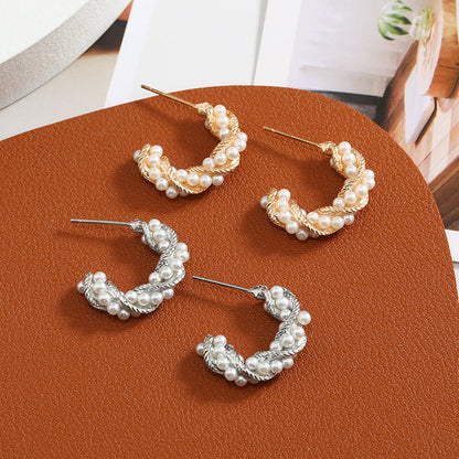 C-shaped earrings, pearl earrings.